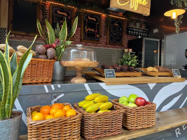 Baskets of colourful fruit and sweet treats on a wooden counter in our on-set craft van.