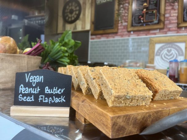 Vegan flapjack slices on a wooden board in our craft kitchen.